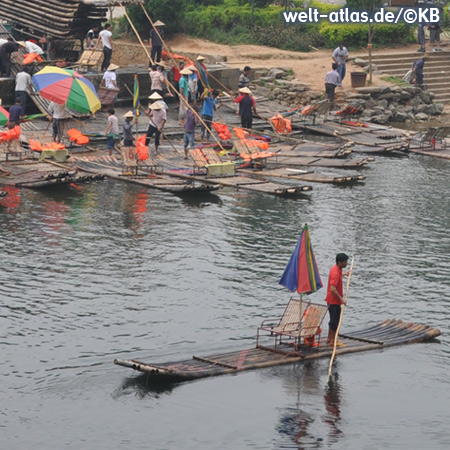 Bamboo rafts with beach umbrellas and deckchairs on Li River