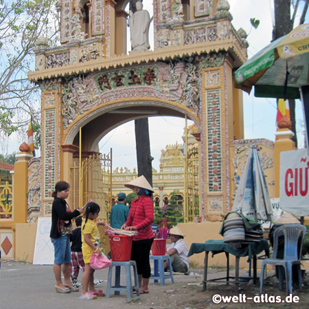 Gate to Buddhist temple with colonial facade, the Vinh Trang Pagoda, My Tho