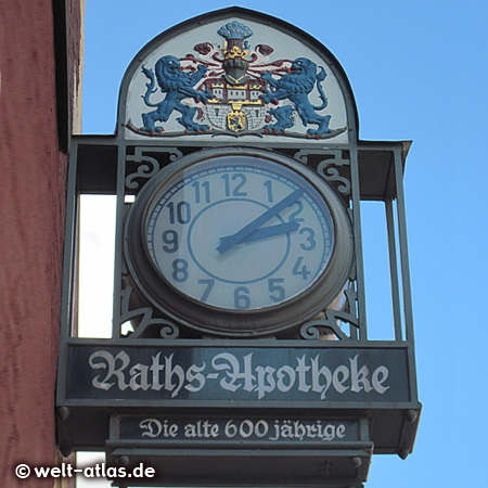 Clock and emblems on the 600 year old pharmacy in Lüneburg – Raths-Apotheke