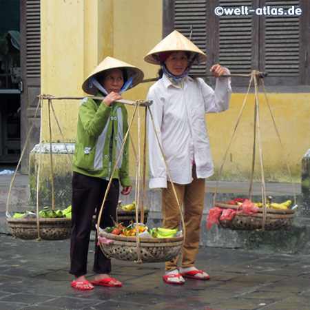 Street Vendors wearing traditional hats, Hoi An