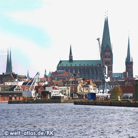 Hansestadt Lübeck mit Hafenanlagen an der Trave und den Türmen der Altstadt, links der Dom und rechts die Marienkirche und St. Petri