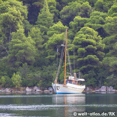 Greek boat anchoring in Limanaki bay on Island of Skopelos, Greece