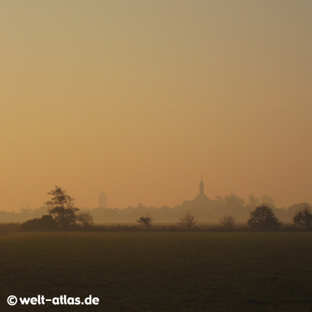 Wesselburen with St. Bartholomäus-Church in early morning haze