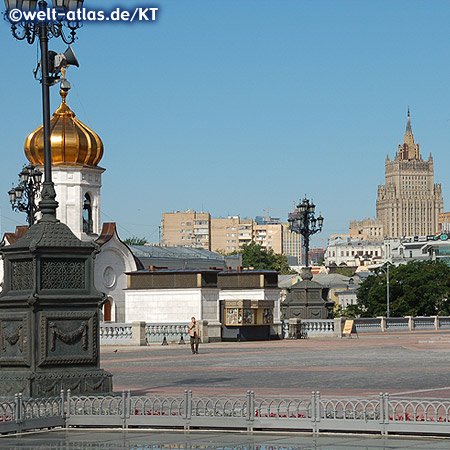View from the square in front of the Christ the Savior Cathedral, chapel and beautiful old lanterns over to the high-rise building of the Foreign Ministry (Stalinist skyscrapers)