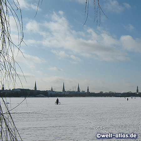 church towers of Hamburg at the frozen Alster Lake