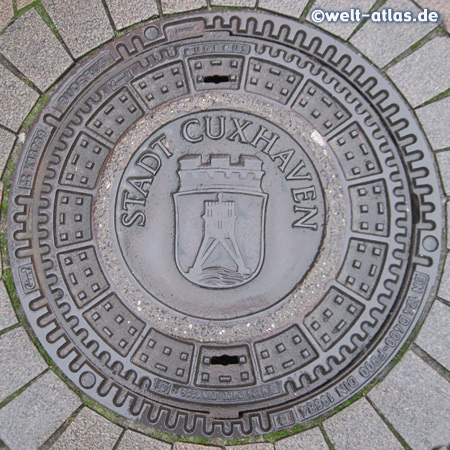 Manhole cover in Cuxhaven with the landmark of the city, the Kugelbake 