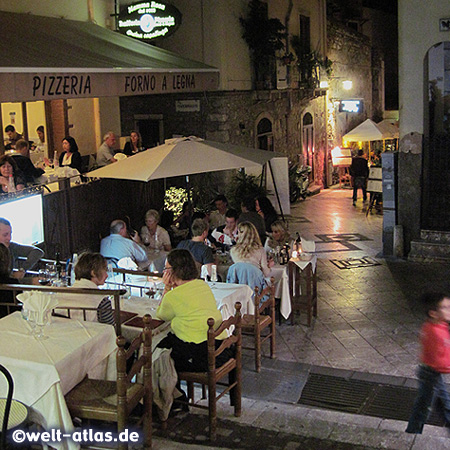 Gasse mit vielen gemütlichen Restaurants in Taormina, Tische und Stühle auf allen Treppen
