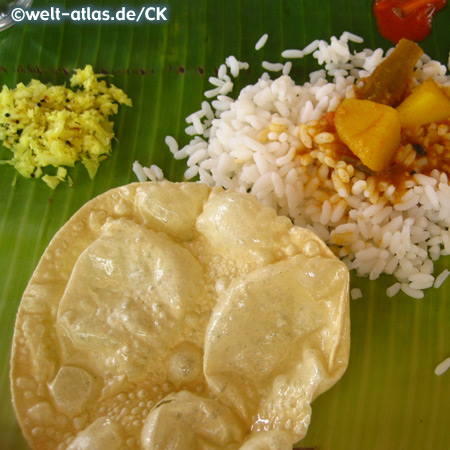 south indian meal with papadams, served on a banana leaf