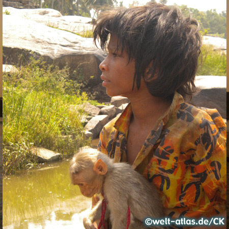 Boy with a monkey in Hampi, India