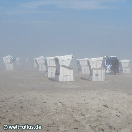 Bright sunshine in St. Peter-Ording at the dike and on the beach near the ground thick fog and it was an unreal atmosphere