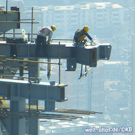 Bauarbeiter in luftiger Höhe auf einem Wolkenkratzer in Shanghai