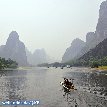 Bamboo rafts with beach umbrellas and deckchairs on Li River